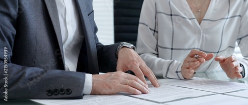 Konstfotografi Business professionals reviewing legal contracts and important documents with a