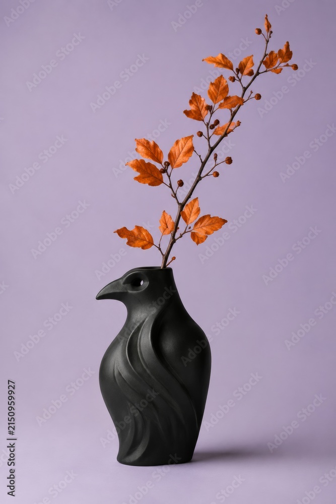 Naklejka premium Black Raven Shaped Ceramic Vase with Orange Autumn Branch