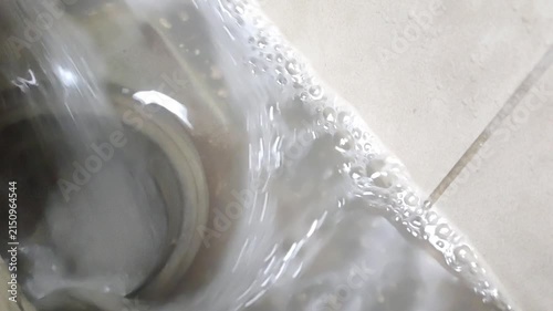 Flowing Water with Bubbles in Ceramic Sink Close Up Household Water Texture Video