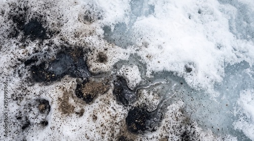 Dark particles on glacier, soot and dust covering melting snow, square environmental detail, blue ice runoff channels, stark negative space for climate science content