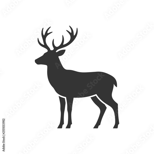 Silhouette of a majestic stag with large antlers standing alert.