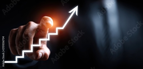 Mans Hand Pushes Glowing Upward Arrow Graph for Business Growth