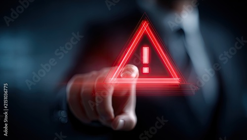 Man Points at Red Warning Triangle Alert Symbol on Digital Screen