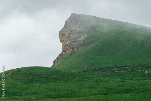 Mountain peak towers over green hills Karachay-Cherkess Republic