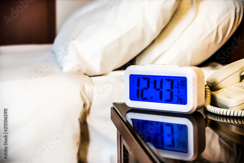 Canvastavla Alarm clock electronic stands on a bedside table near the bed in the hotel