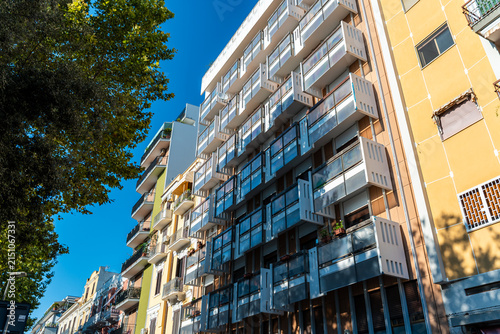 Residential apartment building facade in Bari, Italy with modern balconies and glass railings on sunny day, urban real estate and city living concept