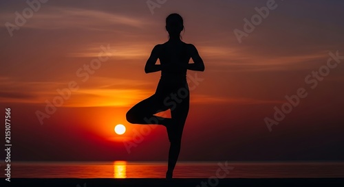 A tranquil silhouette of a person practicing a balancing yoga tree pose against a vibrant glowing sunset over a calm ocean horizon at dusk