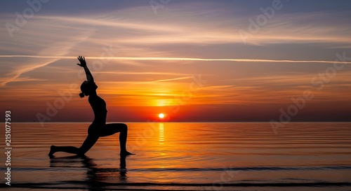 A serene silhouette of a woman practicing a lunge yoga pose on the tranquil water surface during a breathtaking vibrant orange sunset scenery