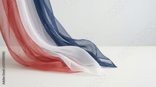 Flowing red white and blue sheer fabric on white background.