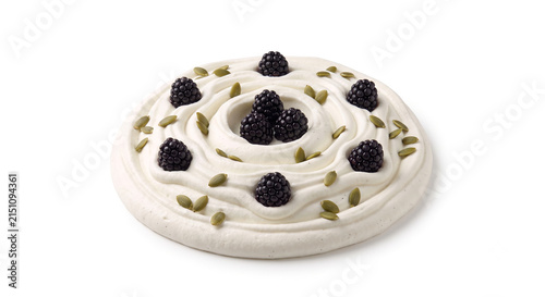 Distant shot of 5 to 10 blackberries and pumpkin seeds nestled on thick white vanilla Greek yogurt