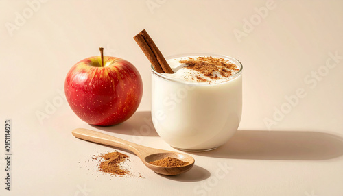 Creamy yogurt with cinnamon, apple slice and cinnamon stick