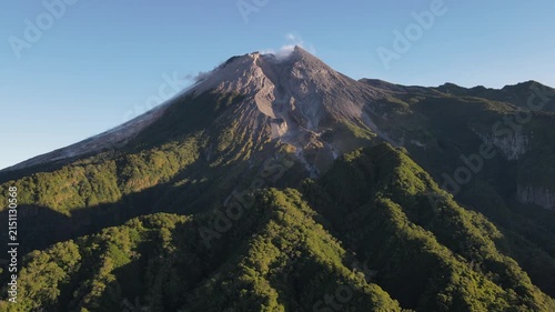 Scenic Aerial Footage of Merapi Volcano with Lush Tropical Forested Slopes During Morning Under a Clear Sky, Vibrant and Wonderful Mountain Scenery of Volcanic Landscape in Yogyakarta, Indonesia.