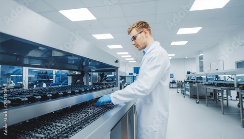 Scientist working in modern laboratory with test tubes
