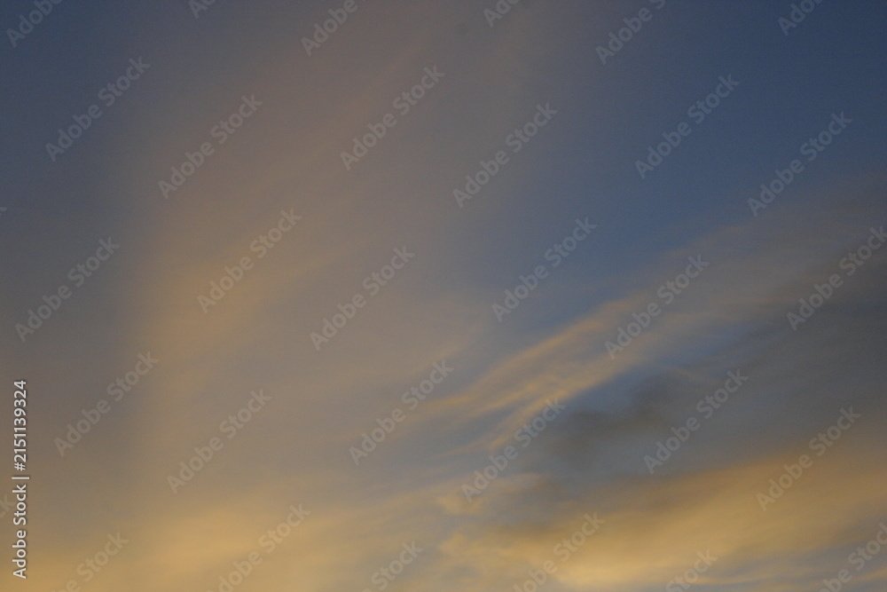 Fototapeta premium Soft golden clouds in the evening sky