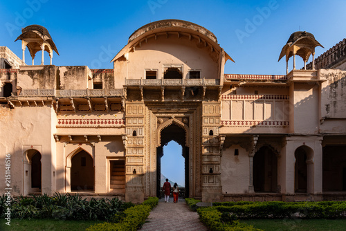 India. Rajasthan. Bundi. A couple walk through the monumental gateway of Garh Palace