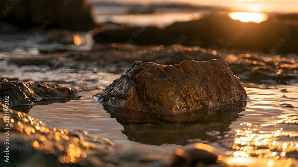 Fototapeta premium Beautiful isolated tide pool at sunset