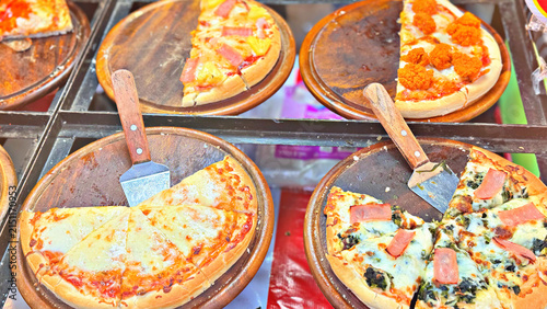 Assorted Pizzas Display on Wooden Boards, Street Food Market Pizza Stall Photography