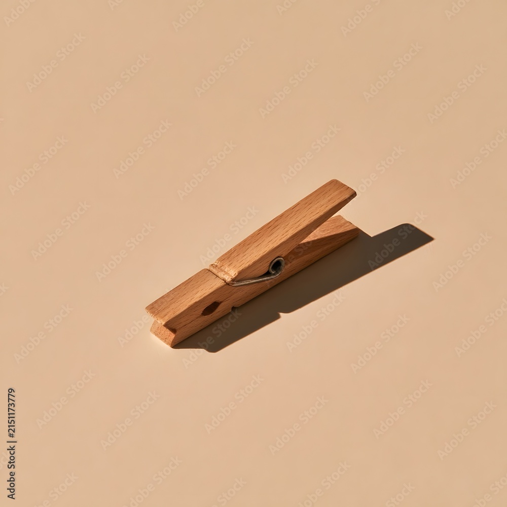 Fototapeta premium Minimalist wooden clothespin peg on soft beige background