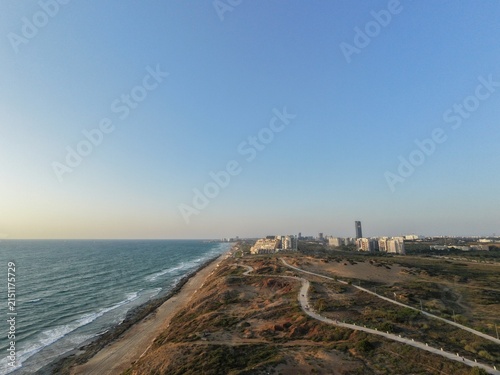 Aerial view of coastline and beach near city