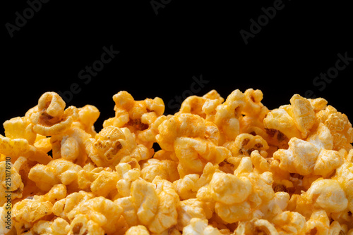 Pile of cheese popcorn on black background.