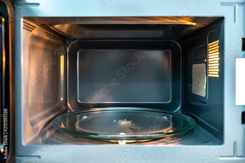 Empty microwave oven with open door. Inside of a modern microwave. Home appliance in the kitchen