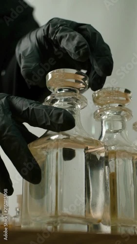 Gloved Hand Closing Glass Perfume Bottle During Fragrance Product Development