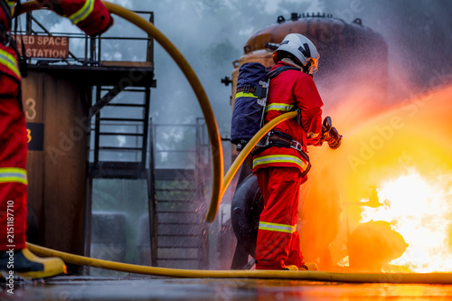 Photography Team of male firefighters in full protective gear and SCBA equipment work togeth
