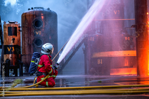 Fotografía Male firefighter in full protective gear and SCBA equipment work to extinguish d