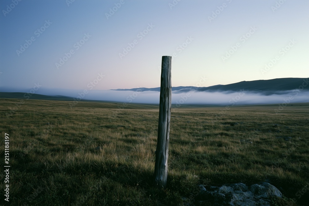 Fototapeta premium Alpine tundra at twilight with ground fog and boundary post