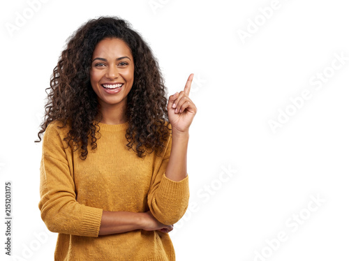 African American woman pointing in yellow sweater