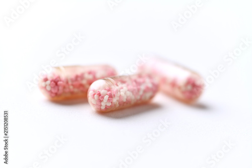 Vitamin B12 (also known as cobalamin) capsules on bright paper background. Soft focus. Close up. Copy space.