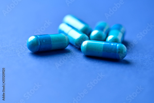 Amino acids capsules on paper background. Soft focus. Close up.