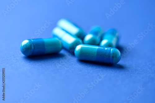 Amino acids capsules on paper background. Soft focus. Close up.