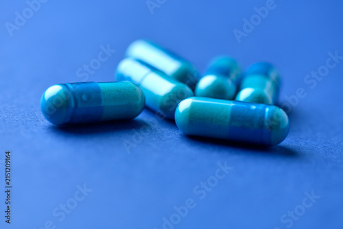 Amino acids capsules on paper background. Soft focus. Close up.