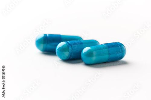 Amino acids capsules on paper background. Soft focus. Close up