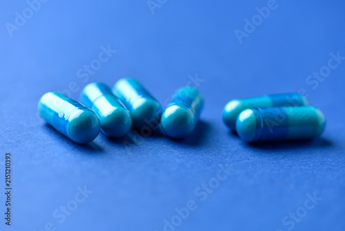Amino acids capsules on paper background. Soft focus. Close up