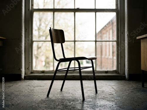Industrial School Chair With A Minimalist Design Against A Clean, Bright Background, Evoking Simplicity And Education.