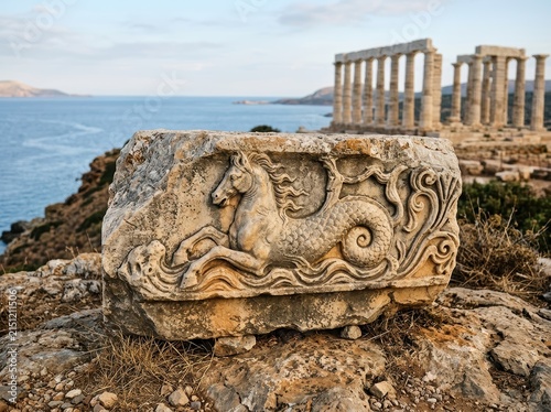 Ancient Weathered Stone Fragment With Intricate Historical Carvings, Evoking A Sense Of History And Mystery.