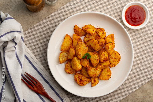 paprika flavor potato.Air fryer baked potatoes in white plate.served with tomato sauce.Healthy cooking.Top view.