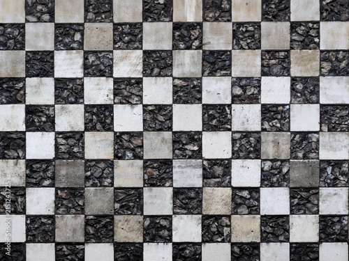Chequerboard stone pattern on medieval church for use as a background texture