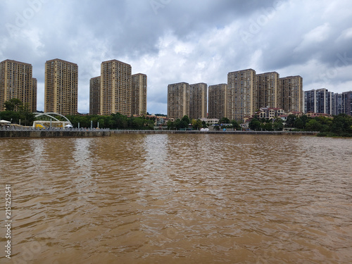 Panoramic view of the lake and high-rise apartment buildings at Kunming Waterfall Park.  KUNMING, YUNNAN, CHINA - JULY 31, 2026