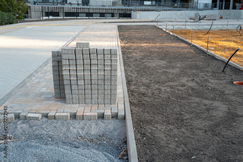 Stacking paving stones for new sidewalk construction