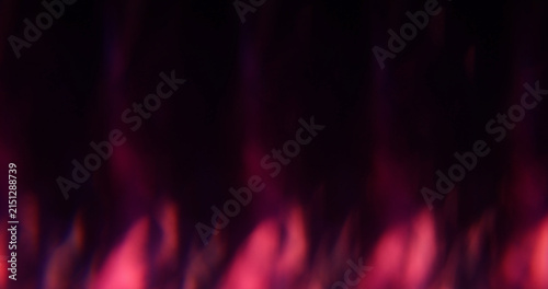 Defocused kaleidoscope flare. Colorful abstraction. Pink blue purple round optical glisten on luminous bokeh dark black background.