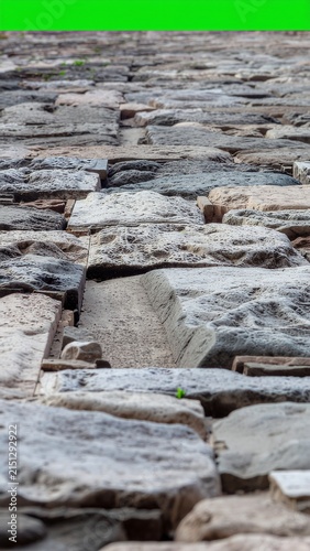 Ancient stone steps leading up green grassy hillside.