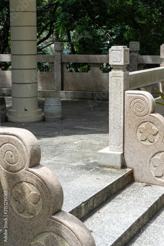 Obraz na płótnie Stone walkway with carved balustrade in garden setting