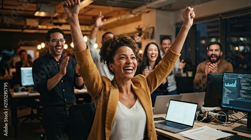 Diverse group of young adults celebrating with arms raised in a lively bar setting