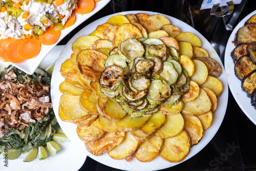 Fotografie Roasted potato slices and grilled zucchini platter served at luxury buffet cater