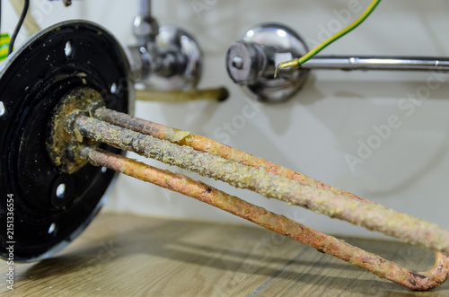 Konstfotografi Heavily scaled water heater immersion heating element removed, showing thick lim