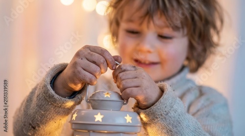 Young child holding a small decorative white lantern.
