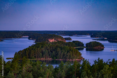 Early morning drone shot of secluded island in Turku Archipelago Finland with calm water and dawn light
